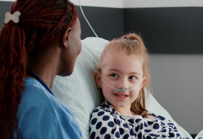 caregiver helping the little girl