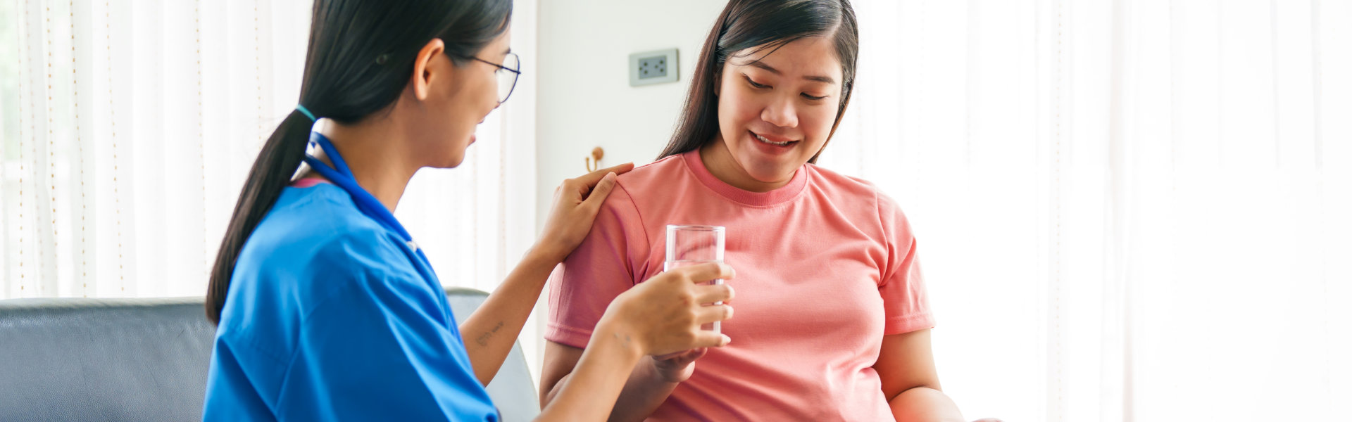 caregiver assisting pregnant woman